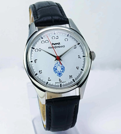 Wristwatch with black leather strap and white dial on a light gray background