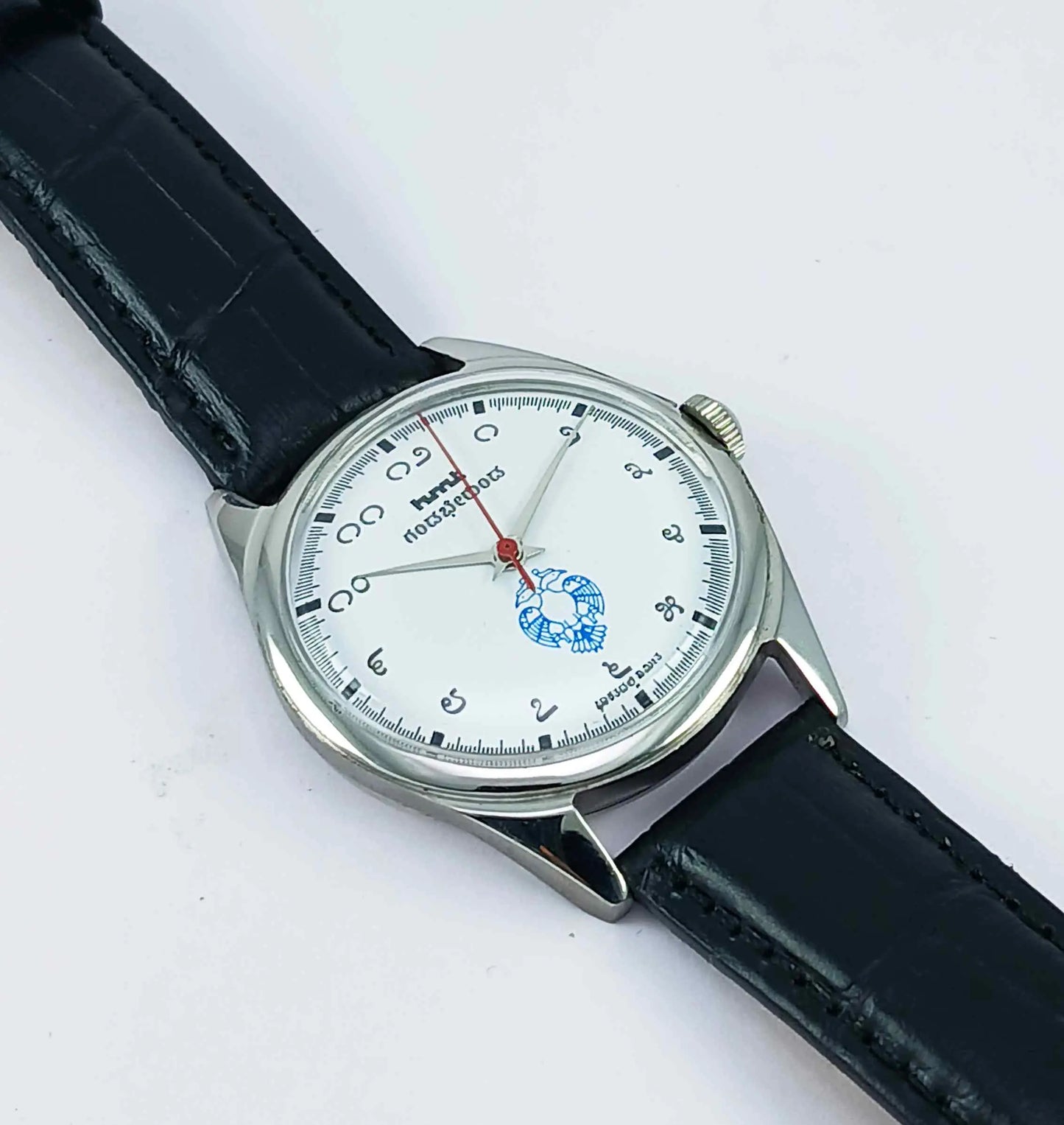 Wristwatch with black leather strap and silver case on a white background