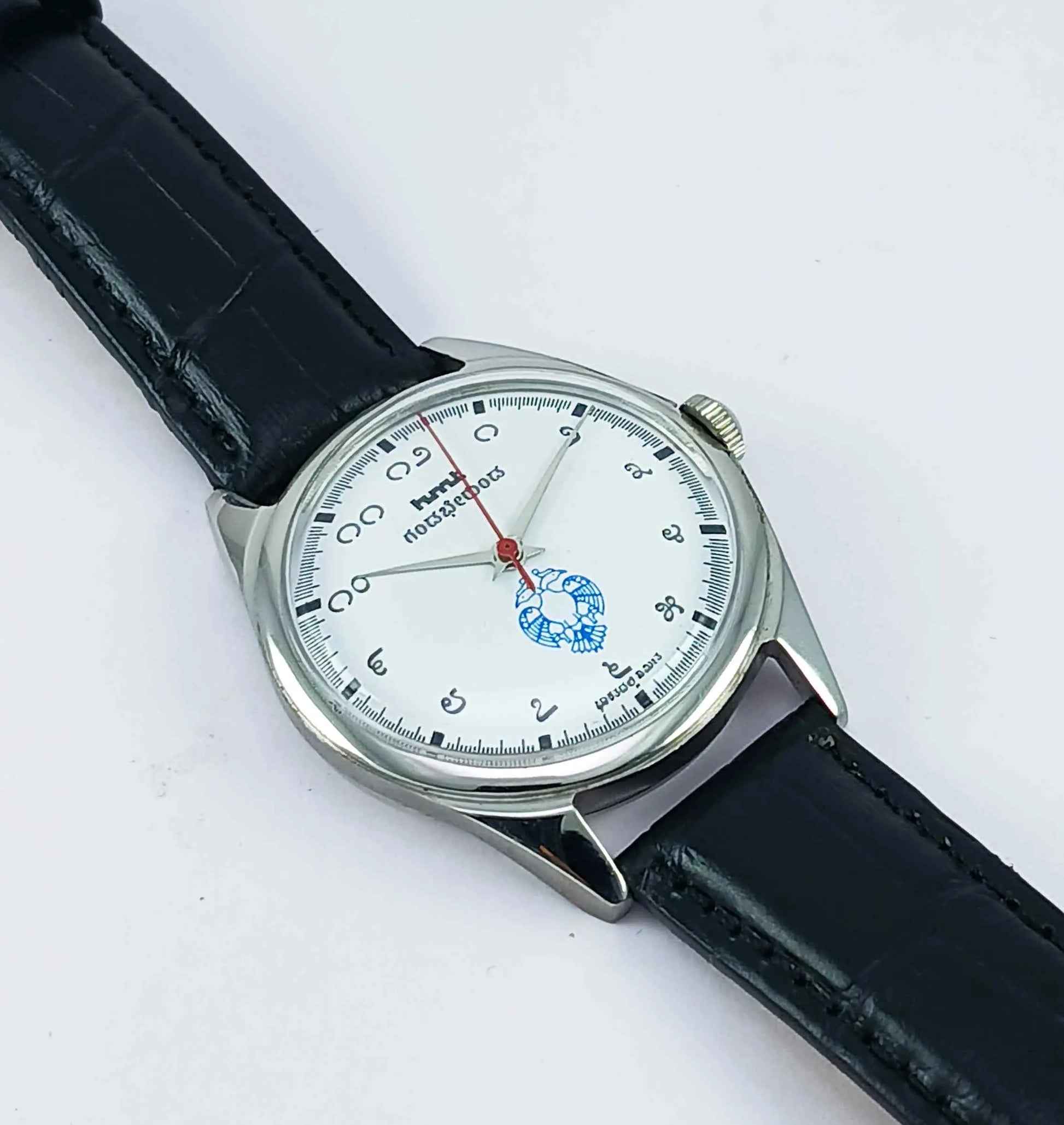 Wristwatch with black leather strap and silver case on a white background