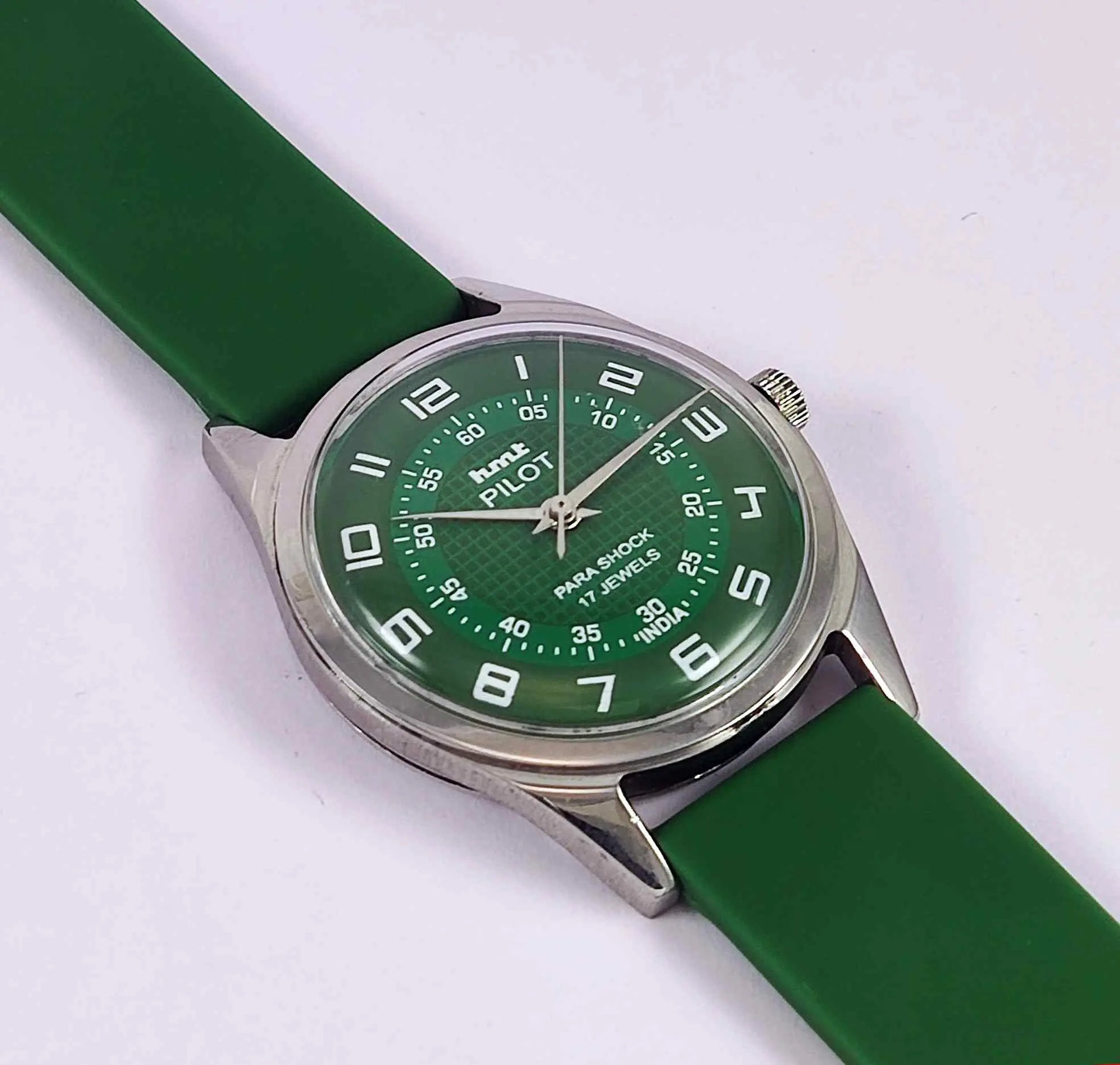 Green watch with a green strap on a white background