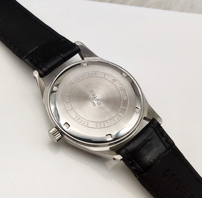 Wristwatch with black leather strap and silver case on a white background